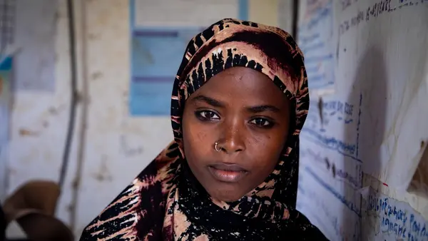 In the drought-stricken Afar region of north-eastern Ethiopia, 16-year-old Fatuma, leans against the white board in her classroom. She is in school instead of in an early marriage thanks to child protection programs supported by UNICEF.