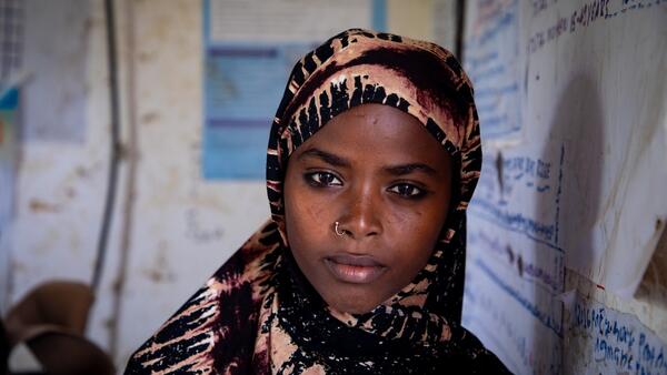 In the drought-stricken Afar region of north-eastern Ethiopia, 16-year-old Fatuma, leans against the white board in her classroom. She is in school instead of in an early marriage thanks to child protection programs supported by UNICEF.