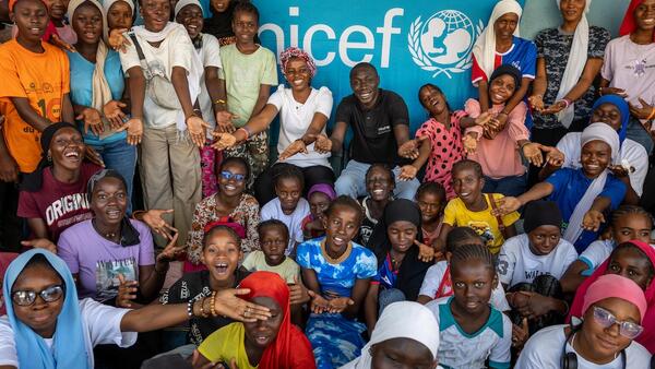 On Jan. 29, 2025, in Kolda, Senegal, members of the local girls club pose for a photo  during a visit from Khaby Lame (center rear, in black shirt). 