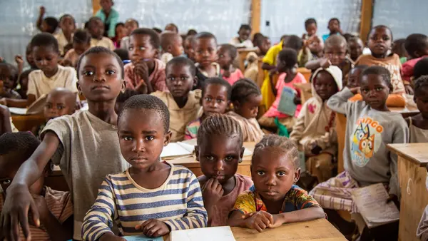 Students in a temporary learning space for displaced children in Kikumbe Village, Democratic Republic of the Congo.