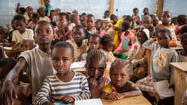 Students in a temporary learning space for displaced children in Kikumbe Village, Democratic Republic of the Congo.