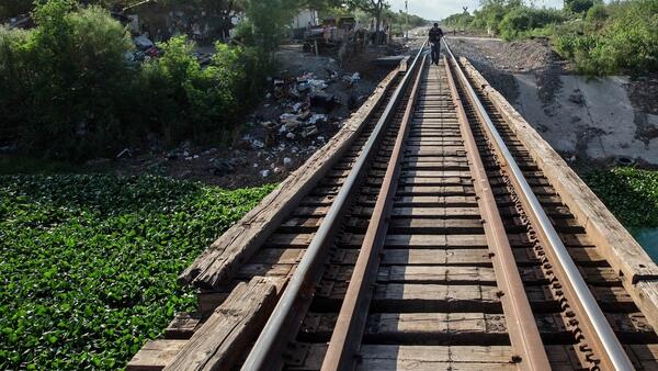 A lonely figure walks the tracks on the outskirts of Reynosa, Mexico, across the Rio Grande from McAllen, Texas.