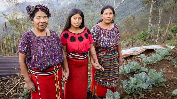 Juana Corio Raymundo, 66, with her daughter Juana Brito Corio, 38, and granddaughter Cecilia, 14, in their garden in the village of La Pista Nebaj, Quiché, Guatemala.