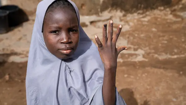 A 12-year-old girl in Katsina, Nigeria, shows her nail marked with ink indicating that she has been vaccinated against the human papillomavirus (HPV).