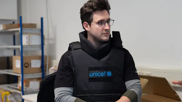 UNICEF Ambassador Doctor Mike samples UNICEF safety gear during visit to the Copenhagen supply warehouse.