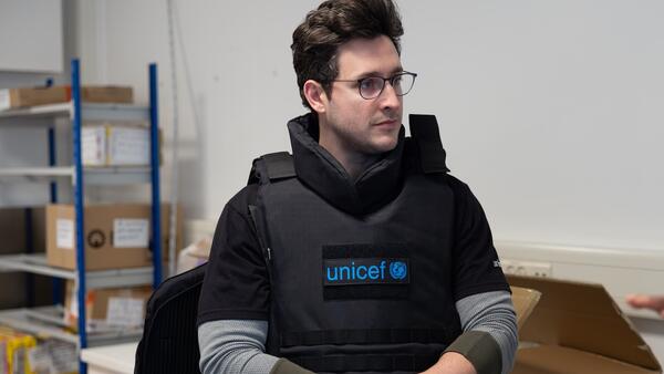 UNICEF Ambassador Doctor Mike samples UNICEF safety gear during visit to the Copenhagen supply warehouse.