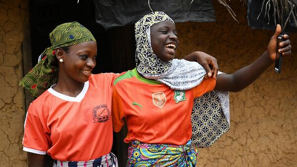 Friends Aicha and Asseta take a selfie in the village of Koda Dioulabougou in southwestern Cote d’Ivoire.