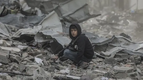 Ten-year-old Qusay searches in the wreckage of his home in in the Al-Touam area in the northern Gaza Strip.
