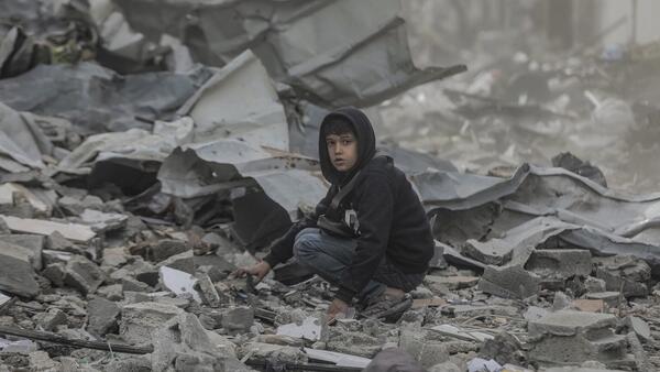 Ten-year-old Qusay searches in the wreckage of his home in in the Al-Touam area in the northern Gaza Strip.