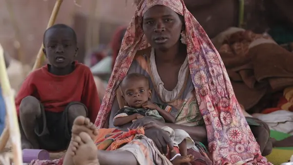 A mother holds her baby son in a temporary shelter in Tawila, North Darfur, Sudan on April 15, 2025. 