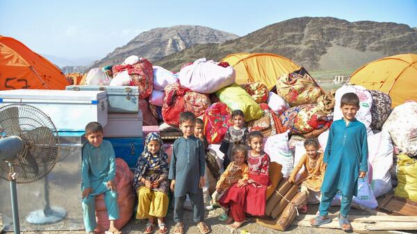 Children with family belongings at the Omari Camp reception center at Afghanistan's eastern Torkham border with Pakistan.