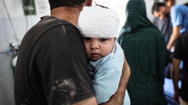 On May 22, 2025, Fares Nassar, 8 months old, receives treatment at Al-Awda Hospital in Nuseirat camp after an airstrike targeted the Al-Hasayneh School, housing displaced Palestinians.