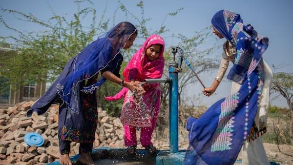 Children using a water pump