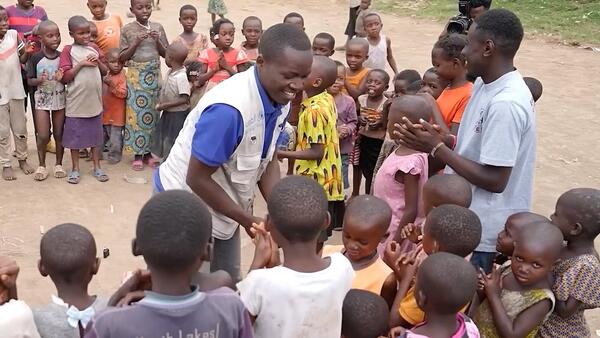 Bienfait, community social worker in North Kivu, DRC, with children he supports.