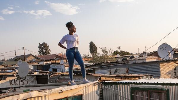 18-year-old stands on top of her family home in the Ivory Park settlement outside Johannesburg, South Africa
