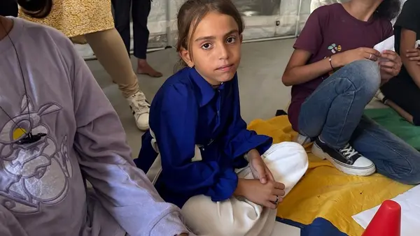 Ten-year-old Waed, center, participates in a UNICEF-supported Mental Health and Psychosocial Support (MHPSS) activity in Khan Younis, State of Palestine.