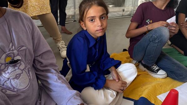 Ten-year-old Waed, center, participates in a UNICEF-supported Mental Health and Psychosocial Support (MHPSS) activity in Khan Younis, State of Palestine.