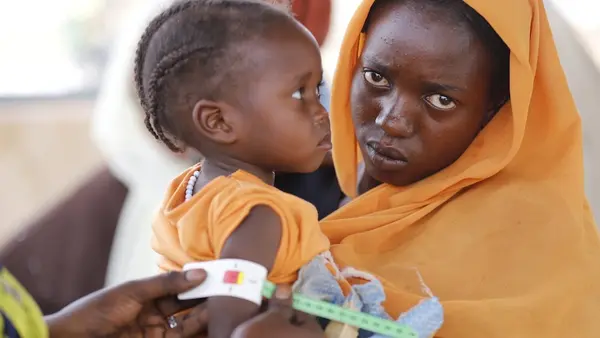 In Tawila, North Darfur, Sudan, a young child's arm measurement shows malnutrition.