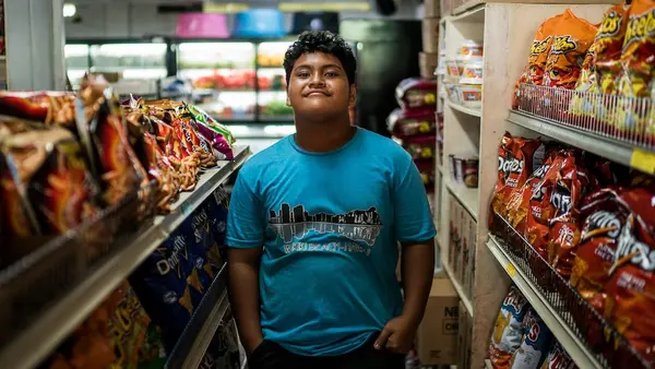 G'okie, 14, stands inside a grocery store in downtown Kolonia, in Pohnpei, Federated States of Micronesia. 