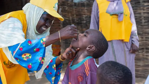 A child receives a polio vaccine during an outbreak response campaign in Central Darfur, Sudan.
