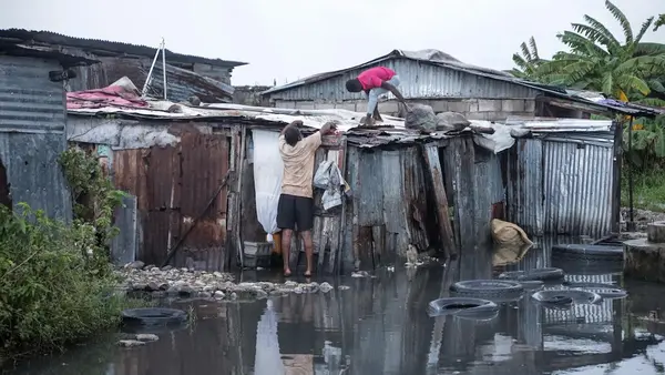 On Oct. 29, 2025, a family repairs their flooded home damaged by Hurricane Melissa in the southern region of Les Cayes in Haiti.