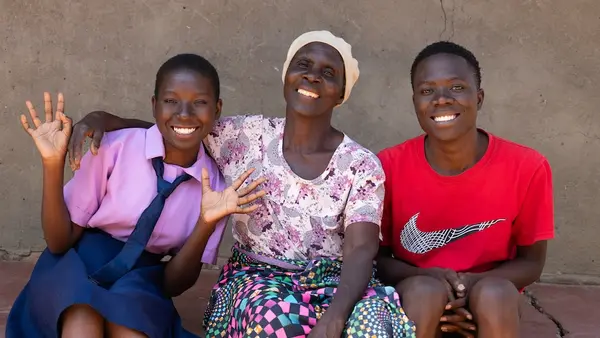 A 16-year-old K.I.N.D. Fund scholarship recipient, far left, with her grandmother and brother in Malawi. 