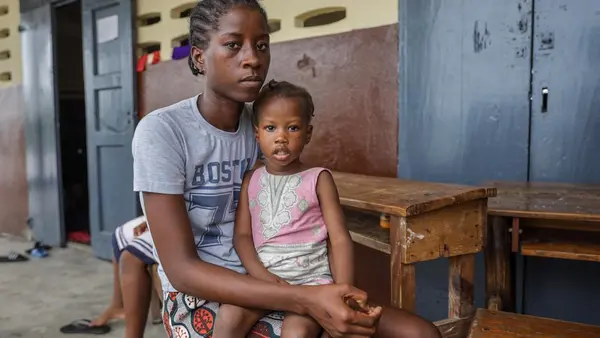 In Haiti, Naika Bienvil, 21, and her 2-year-old daughter take refuge in a school converted into a shelter as Hurricane Melissa approaches.