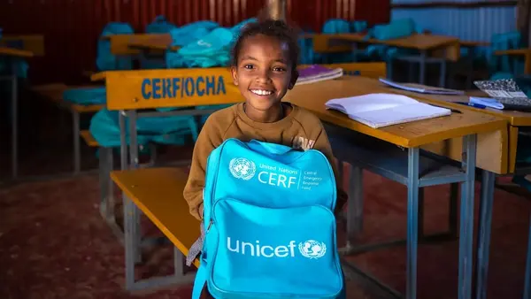 A 9-year-old girl holds her UNICEF backpack in a UNICEF-supported classroom in Tigray, Ethiopia.