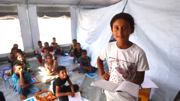 Children study in a temporary learning space created by UNICEF and partners in Deir al-Balah, Gaza. 