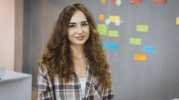 A girl in Ukraine smiles during her internship, supported by UNICEF, to help young women try out careers and build confidence