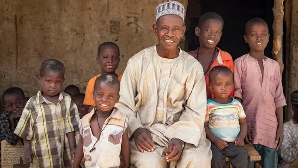 A local leader in Dala, Borno state, Nigeria, with his grandchildren and other kids who received vaccinations with UNICEF's support.