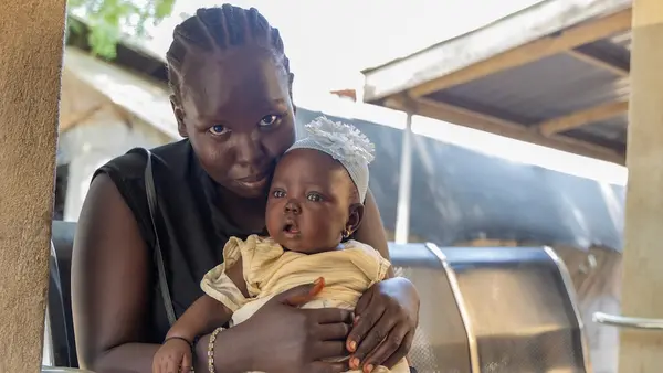 A mother brings her baby for routine vaccination at UNICEF-supported Munuki Health Center in Juba, Central Equatoria State, South Sudan.