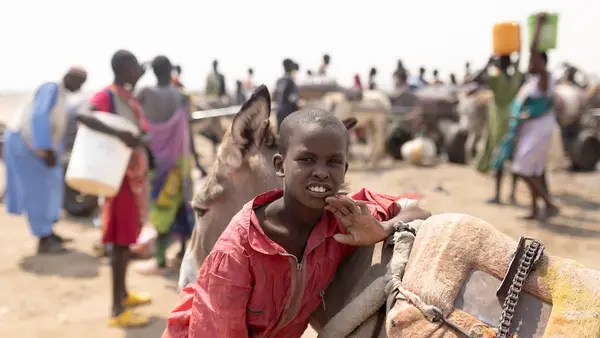 Malik, 10, arrives at a water point in White Nile State, Sudan.