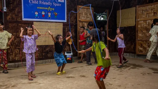 Girls jump rope in a child-friendly space in Myanmar.