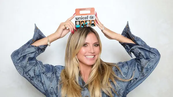 UNICEF Ambassador Heidi Klum holds a Trick or Treat for UNICEF box.
