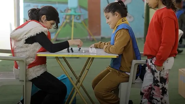 Children play chess in a UNICEF-supported child-friendly space in the Gaza Strip. 