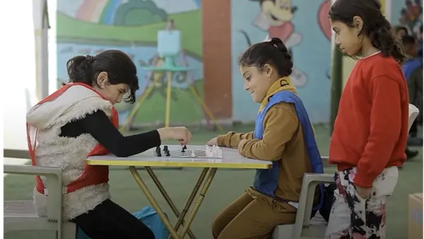 Children play chess at a UNICEF-supported child-friendly space in Lebanon.