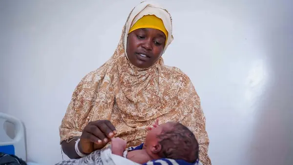 A mother in Somalia holds her newborn son, delivered in a UNICEF-supported facility.