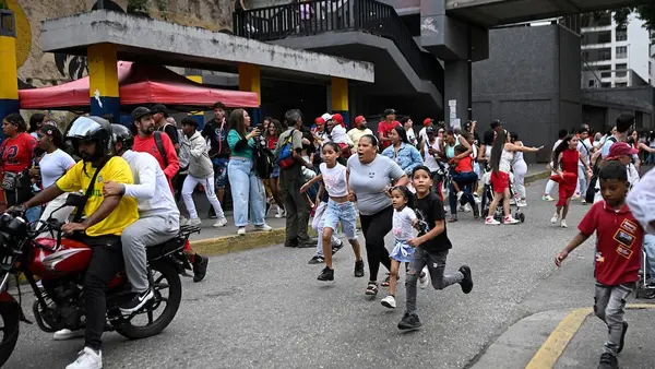 People run into a street following an earthquake in Caracas on June 24, 2026.