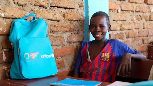 TOP PHOTO: Ayman Adam, 12, sits in a classroom at Al Imtidad School, supported by UNICEF, in Farchana, eastern Chad with a UNICEF-provided backpack full of supplies to help him learn. 