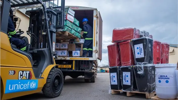 A man uses a forklift to load Ebola outbreak response supplies onto a truck.