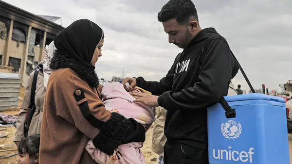 UNICEF worker attending to a baby
