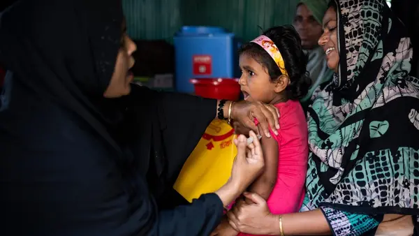 Four-year-old girl in Bangladesh receives a typhoid vaccine.