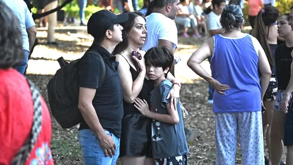 Families wait anxiously in a park in Cali after evacuating their homes following a major earthquake in Colombia. 