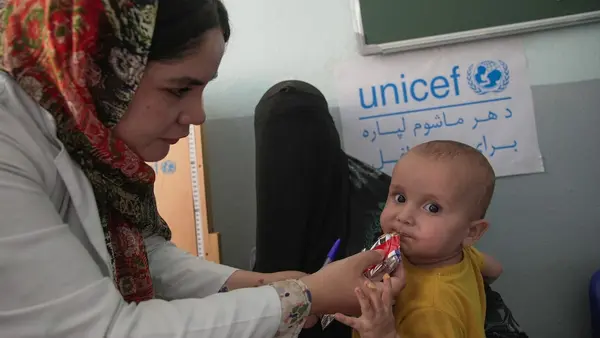 On June 30, 2026, a 15-month-old boy receives ready-to-use therapeutic food at Nawabad Clinic in Herat province, Afghanistan.