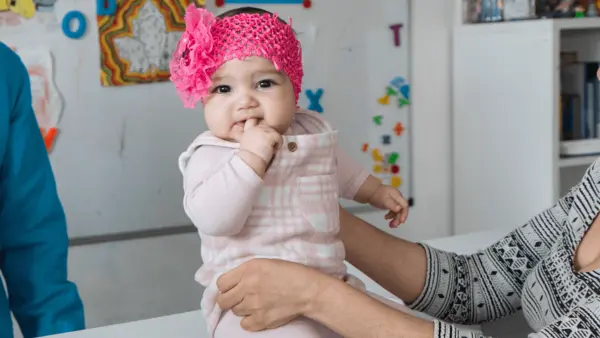 Baby being held in a UNICEF center