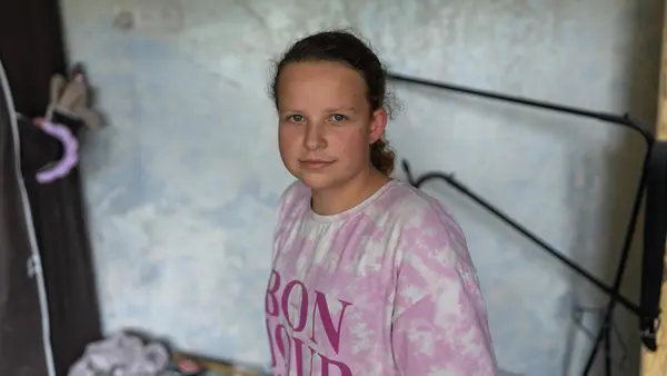 On Sept. 1, 2026, Sofiia, 14, stands in her family's apartment, damaged in an overnight attack in Boryspil, Kyiv region, Ukraine.
