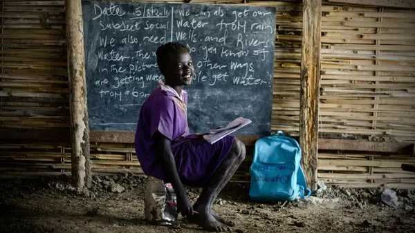 Child In Front of Blackboard