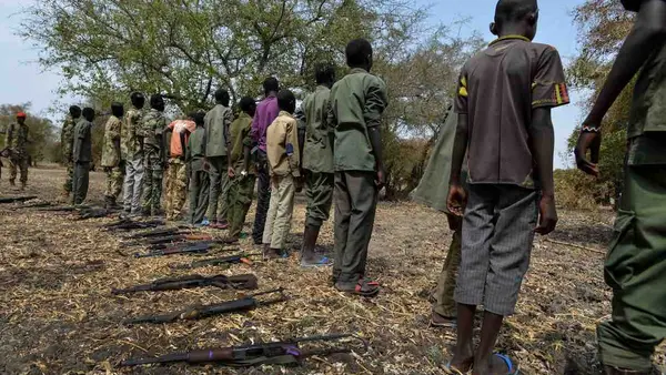 Children surrender their weapons during a ceremony formalizing their release from the SSDA Cobra Faction armed group, in Pibor, South Sudan.