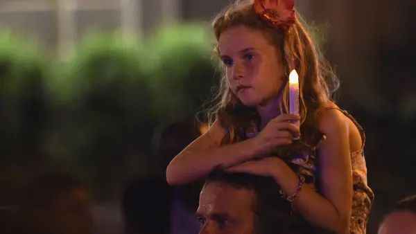Child Holding Candle at Vigil